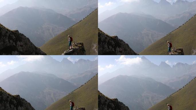 女徒步旅行者从山谷上方的山脊望出去