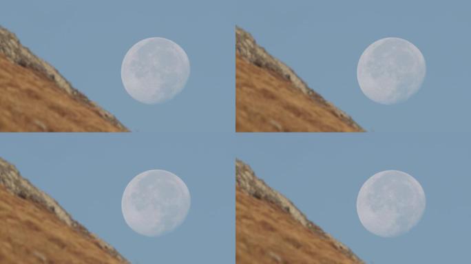 超级变焦拍摄的月亮旁边的山坡