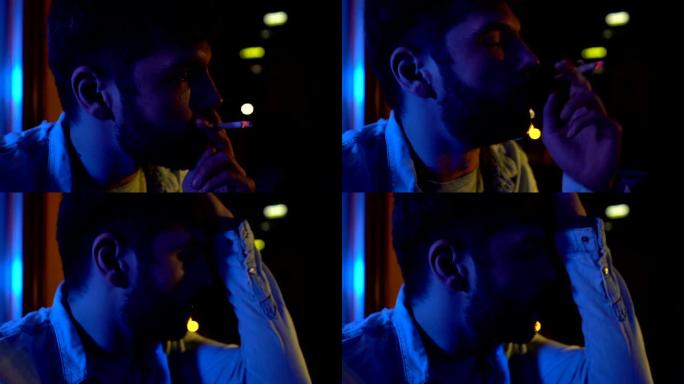 紧张的男人晚上吸烟坐阳台，思考问题，缓解压力