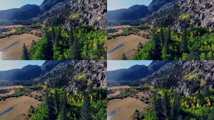 当树木变色时，美丽的无人机在加利福尼亚山区的一条寂寞道路上拍摄。