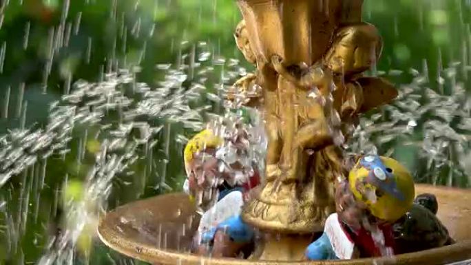 喷泉水在花园中飞溅的超慢动作/泰国