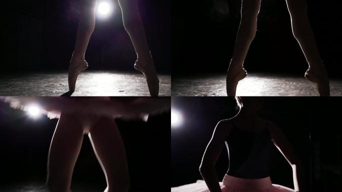 黑色背景上脚尖鞋优雅的女性腿。芭蕾舞练习。芭蕾舞者美丽纤细优美的双腿。慢动作。