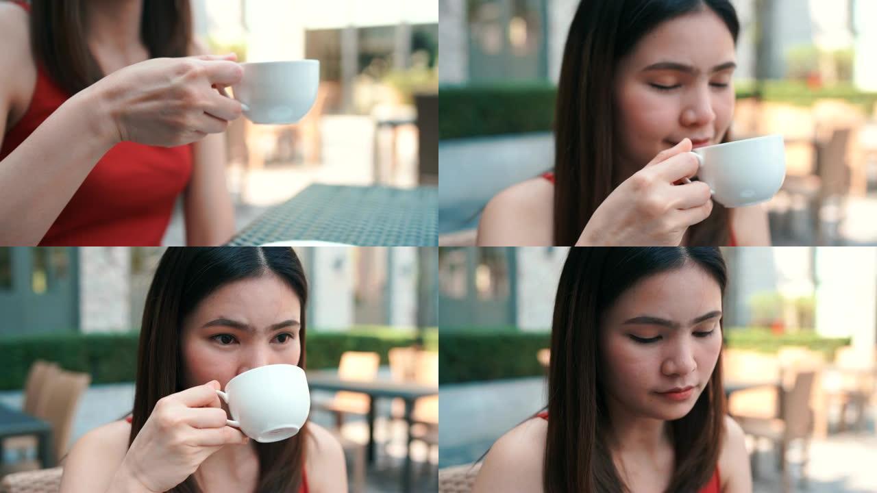 4k镜头特写美丽的手和脸，女人喝着热咖啡。