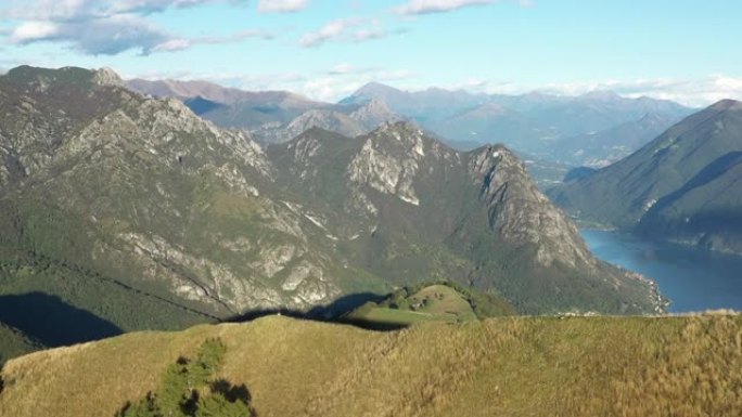 日落时卢加诺湖的空中无人驾驶飞机视图，望向甘德里亚