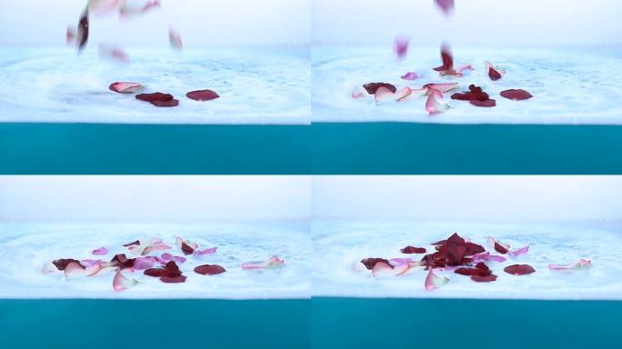 玫瑰花瓣落在水泡沫上，在水疗护理前准备沐浴
