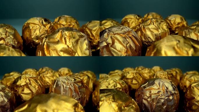 相机在成排的美味美丽的巧克力球糖果旁边缓慢移动