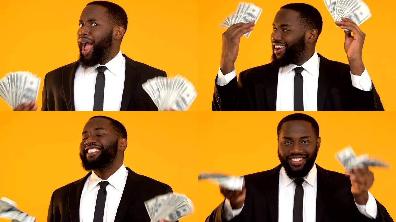 非常快乐的非洲裔美国人挥舞着一堆美元，启动利润