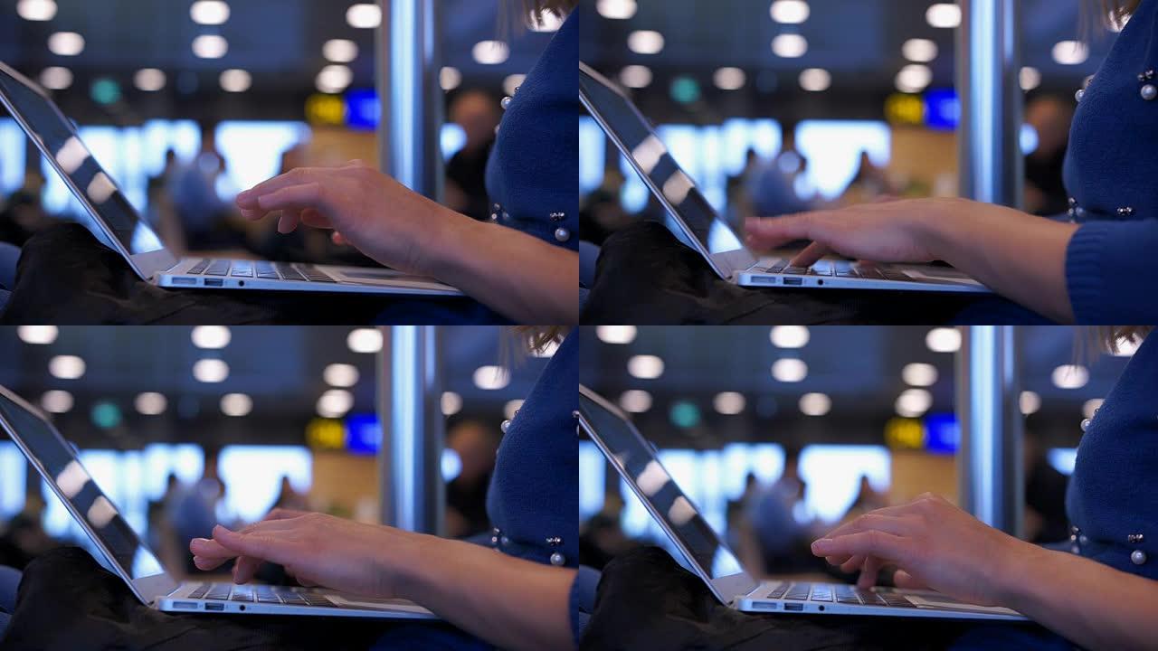 忙碌的女人在机场大厅的笔记本电脑上工作，航班延误，在咖啡馆等候