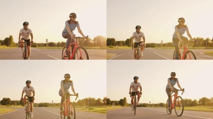 Steadicam拍摄了两个健康的mem和女人在日落时用自行车公路自行车快速兜售的照片。