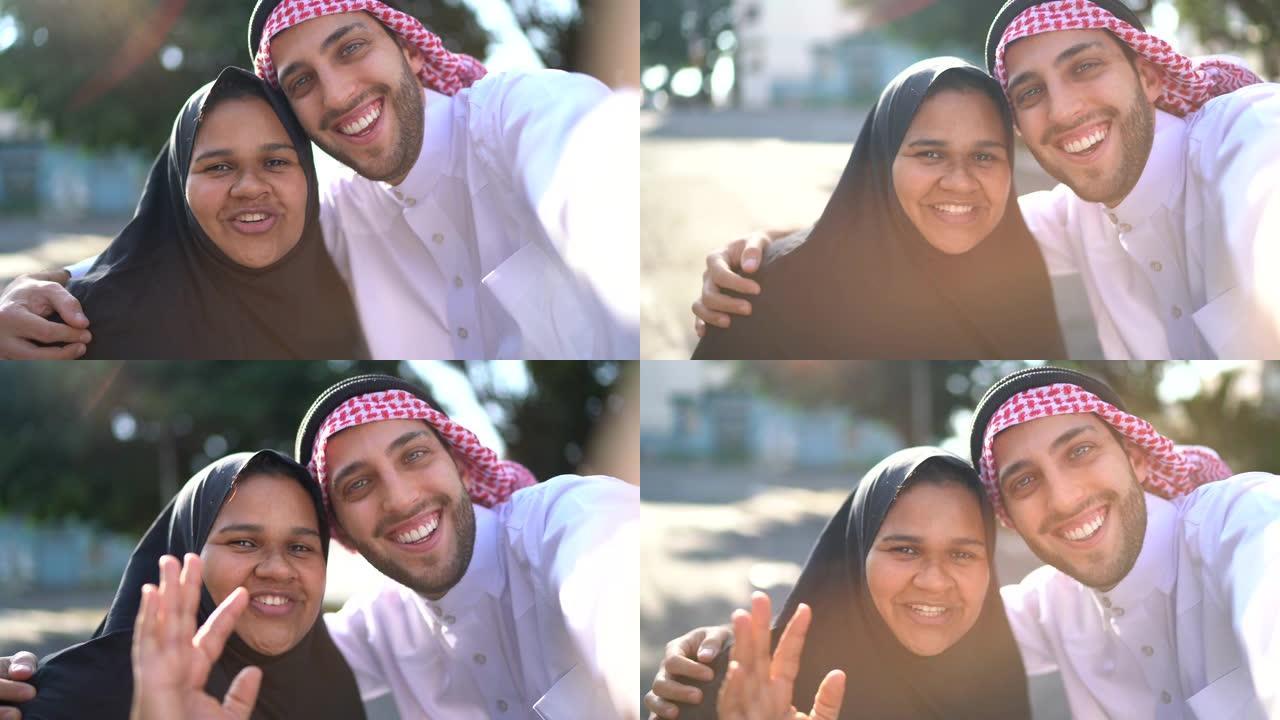 阿拉伯中东夫妇在街上自拍/视频通话