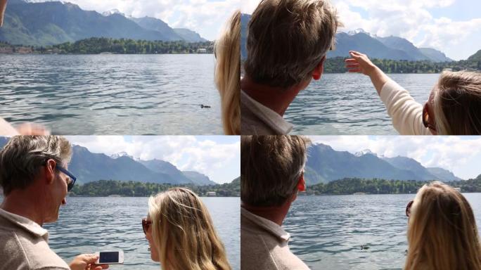 夫妇在湖上拍摄智能手机照片