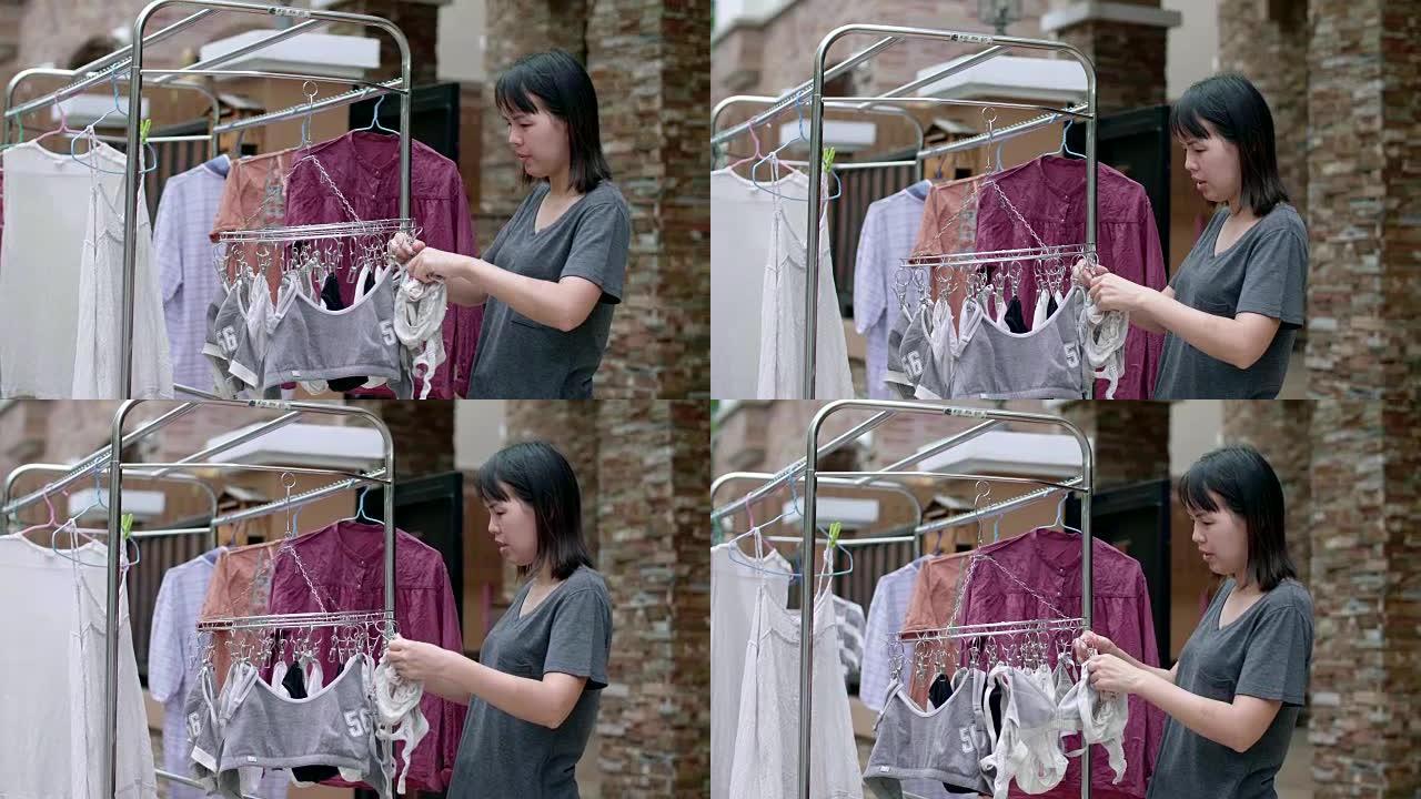 女人在阳台上洗衣服