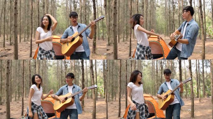 亚洲年轻夫妇弹吉他唱歌享受在松林露营