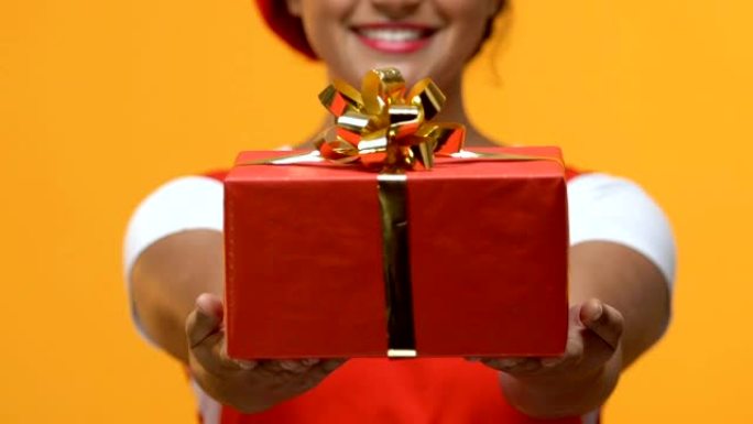 快乐的美国黑人女性手中拿着红色礼品盒，节日问候