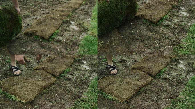一个穿着因果服装的年轻高加索人在住宅后院里放了一块草皮草的正方形
