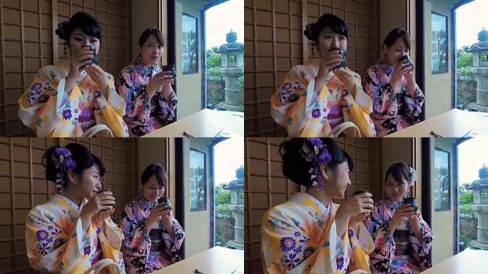 日本年轻女性穿着传统和服喝茶