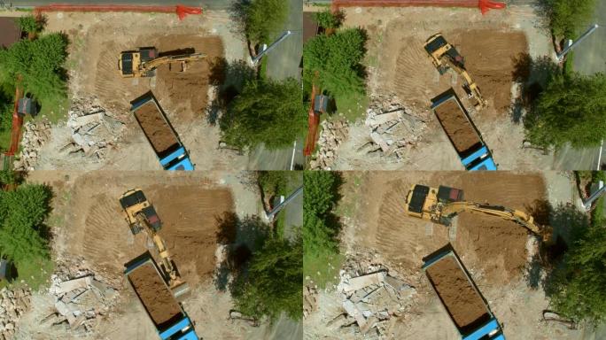在挖掘机上进行空中关闭，将挖出的土壤装载到建筑工地的卡车上