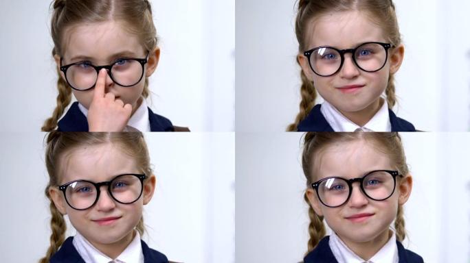 聪明的女学生调整眼镜特写，小学生教育