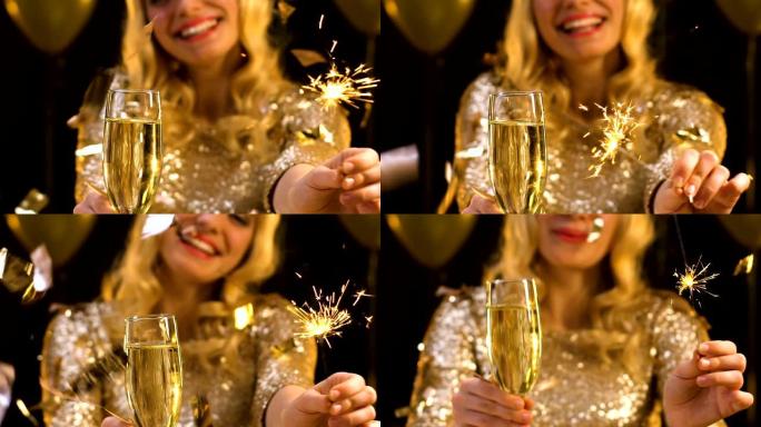 金发女人拿着香槟，在掉落的五彩纸屑下挥舞着孟加拉的光