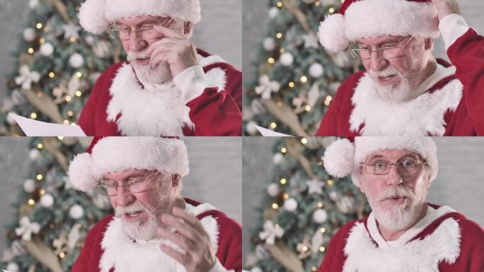 惊讶的圣诞老人读信，看着相机，摇摇头的特写镜头。白胡子的白人老人对现在一无所知。电影院4k ProR