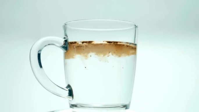 用开水从水壶倒入玻璃杯中，放入汤匙咖啡