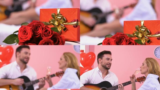 礼物和玫瑰在床上，男人弹吉他，给女人唱浪漫的情歌