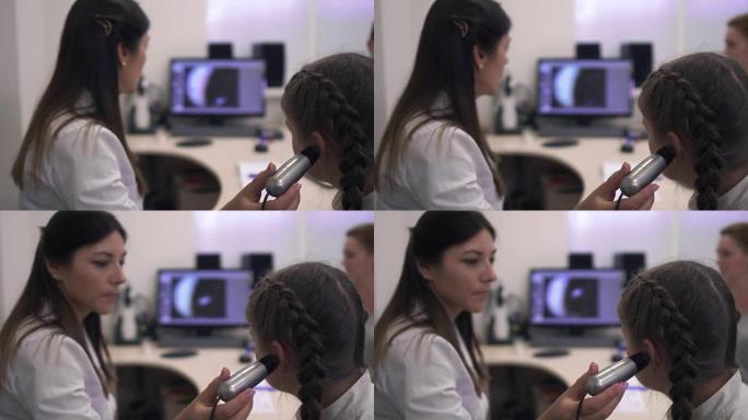 小女孩检查听力医生用设备检查听力耳科耳聋