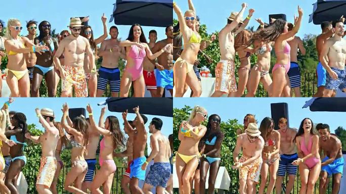 参加聚会的年轻男女在阳光下的游泳池旁跳群舞