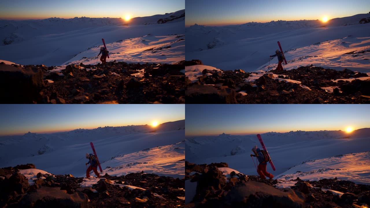 滑雪者在日出时在高加索山脉的岩石山上徒步旅行