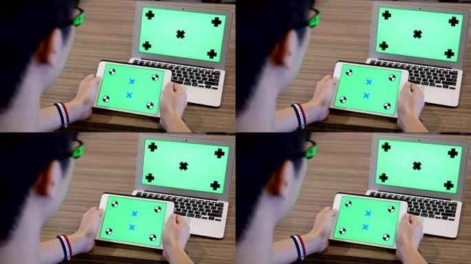 年轻人拿着绿色屏幕的空白平板电脑