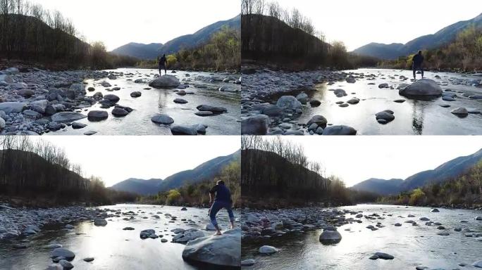 人在河边扔石头