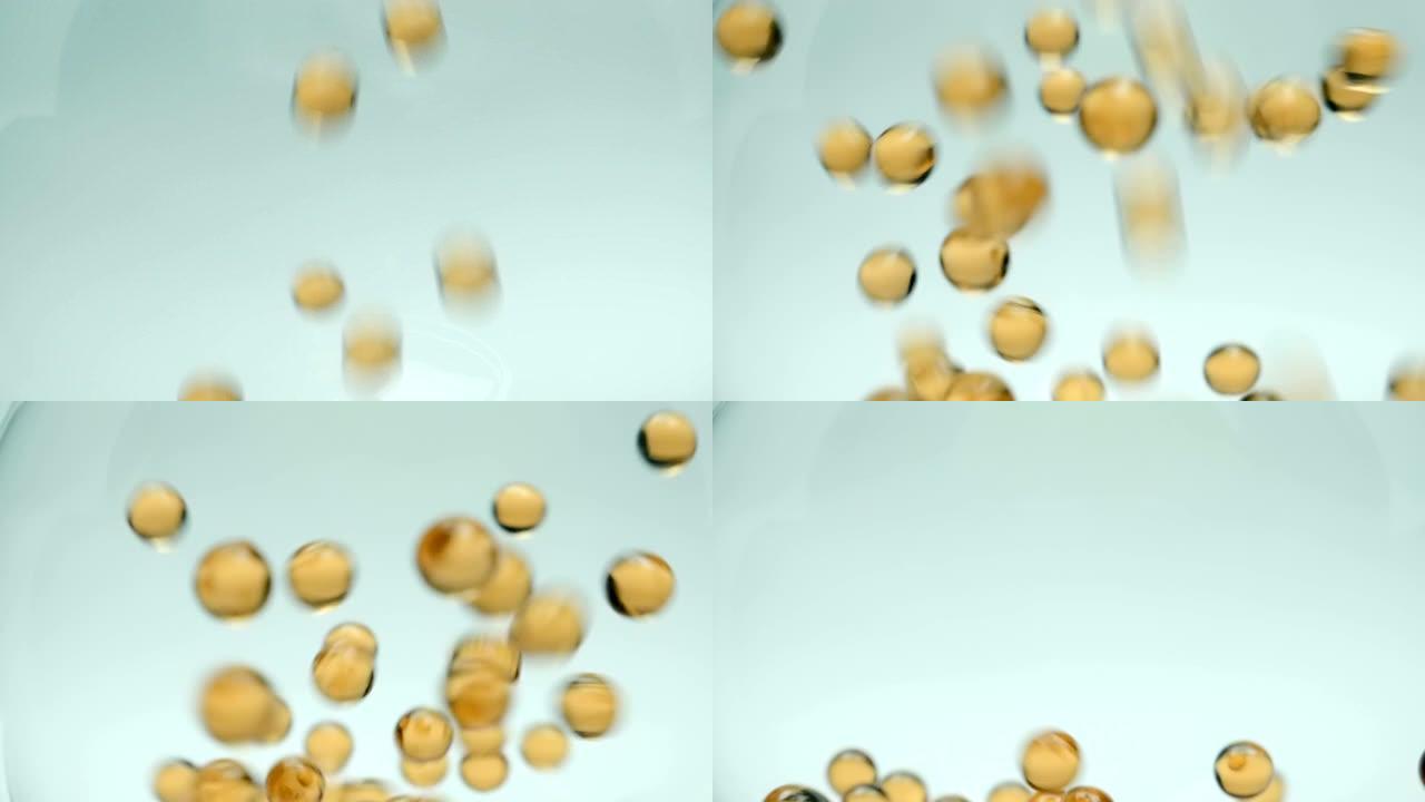 黄色omega-3鱼油胶囊掉落并弹跳，相互碰撞