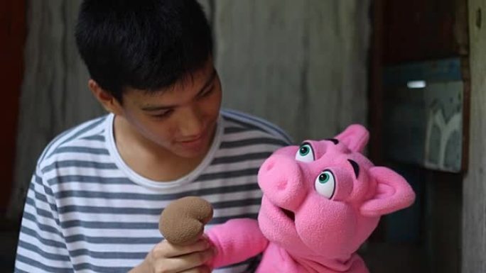玩猪手木偶的男孩开心大笑留守儿童