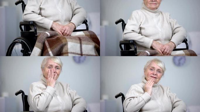 坐在轮椅上的老太太擦着脸的眼泪看着相机，孤独