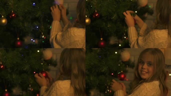 小女孩挂圣诞树玩具，节日装饰，特写