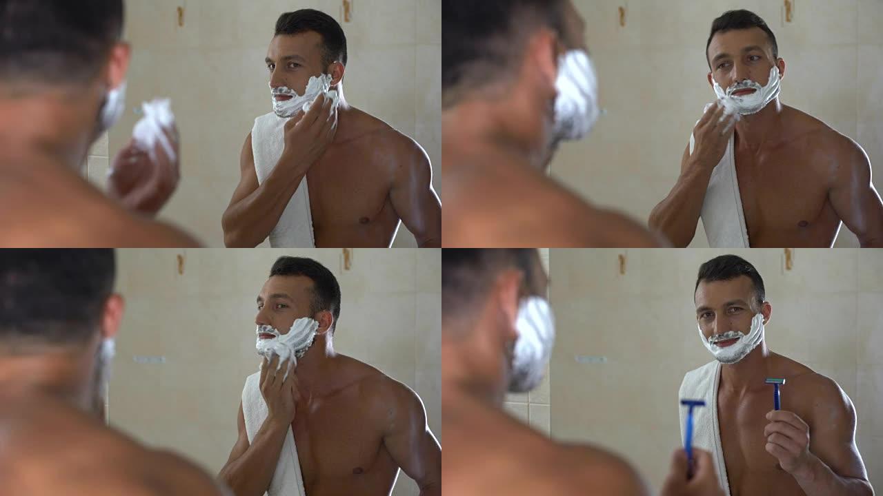 残忍的男性展示剃须刀，并将剃须膏涂抹在脸部和胡须上