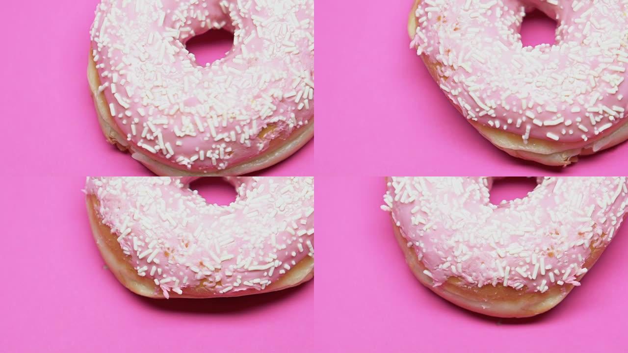 旋转的粉红色桌子上的甜甜圈，过量的糖，糖尿病，甜点特写