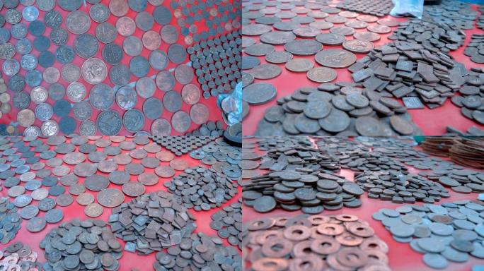 印度瑞诗凯诗的红色柜台上堆放着大堆的老式印度硬币