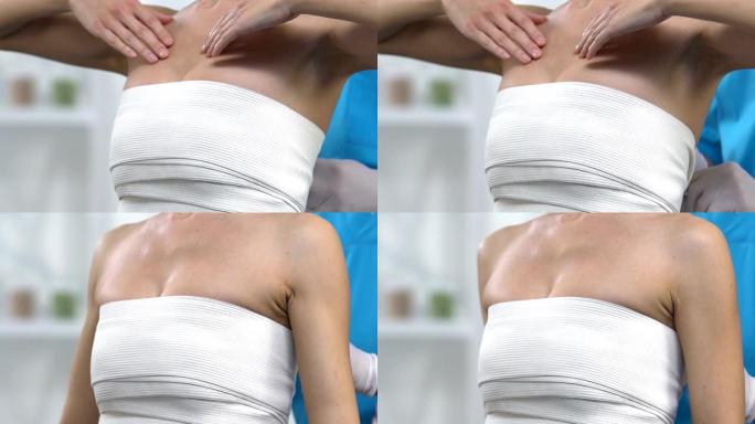 男性整形外科医生将弹性贴合乳房包裹在女性胸部，乳房成形术