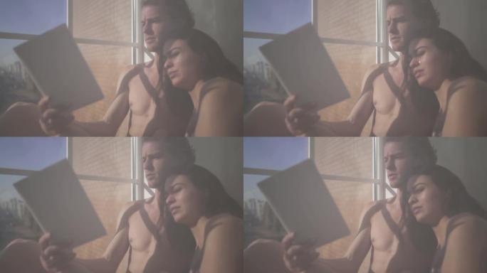 美丽性感的裸体女人和年轻的裸体金发男人躺在一起，她透过薄纱在窗户附近看书。女性脸上流着眼泪。