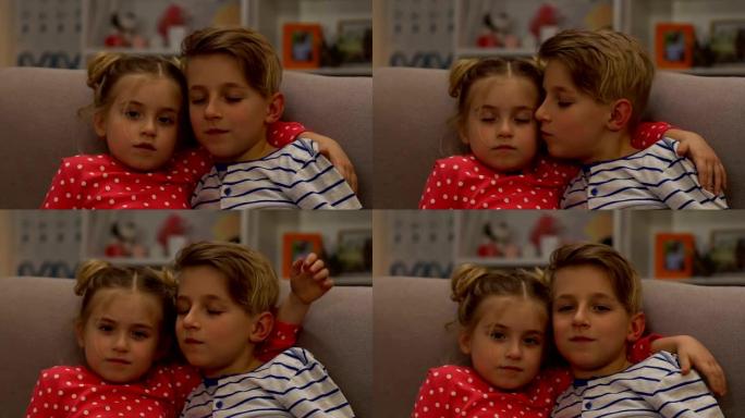 小弟弟和妹妹拥抱，男孩亲吻女孩在脸颊护理，慢动作