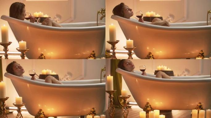 女人享受快乐，躺在浴缸里喝泡沫，喝红酒，在豪华的水疗胜地度过时光。