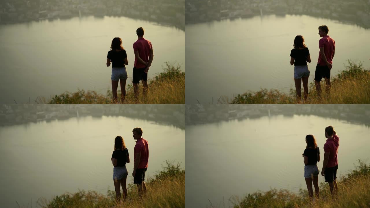 年轻夫妇朝夕看，并欣赏下面的湖景