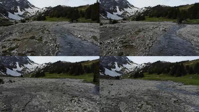 瑞士阿尔卑斯山的山间溪流从积雪中流出
