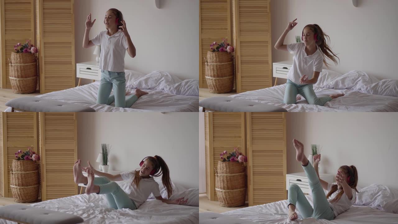 有趣可爱的小女孩戴上耳机，试图跳舞，摔倒在床上。