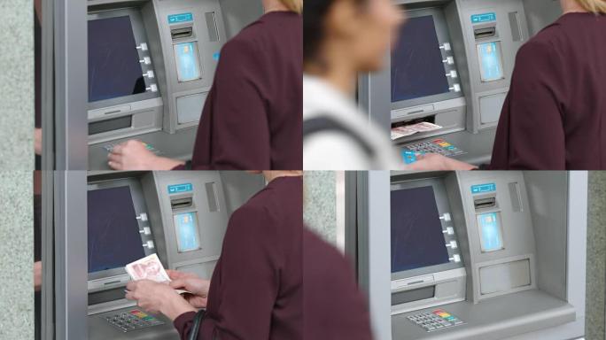 LD女人从自动取款机中取出银行卡并从自动提款机中取钱