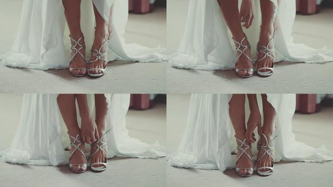 美丽的新娘在婚礼当天穿上鞋子