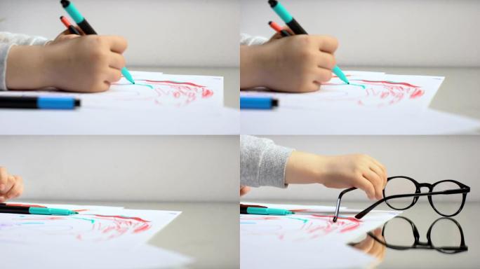 儿童用铅笔画画，摘下眼镜，色盲治疗