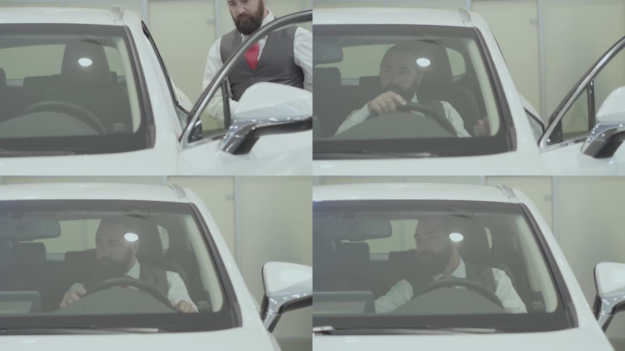 肖像迷人的自信的大胡子商人坐在车上，检查从汽车经销店购买的新汽车。