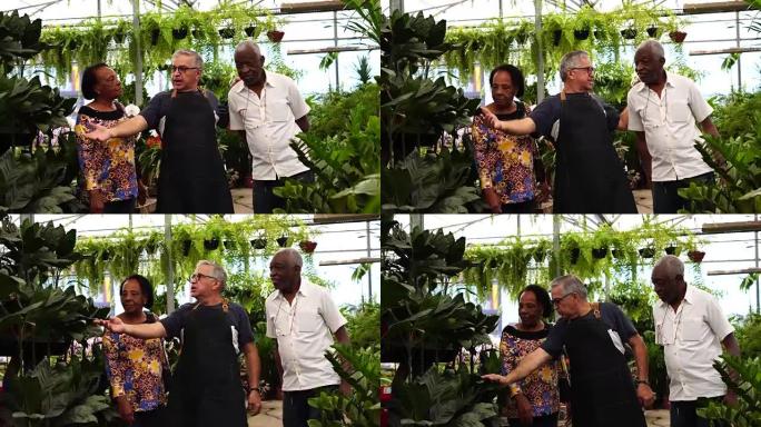成熟的非洲夫妇顾客在花卉市场购买